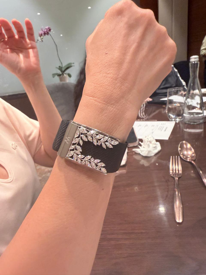 Leaf-design WHOOP accessory worn on a black band