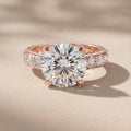 Rose Gold Round Cut Moissanite Engagement Ring with Side Stones
