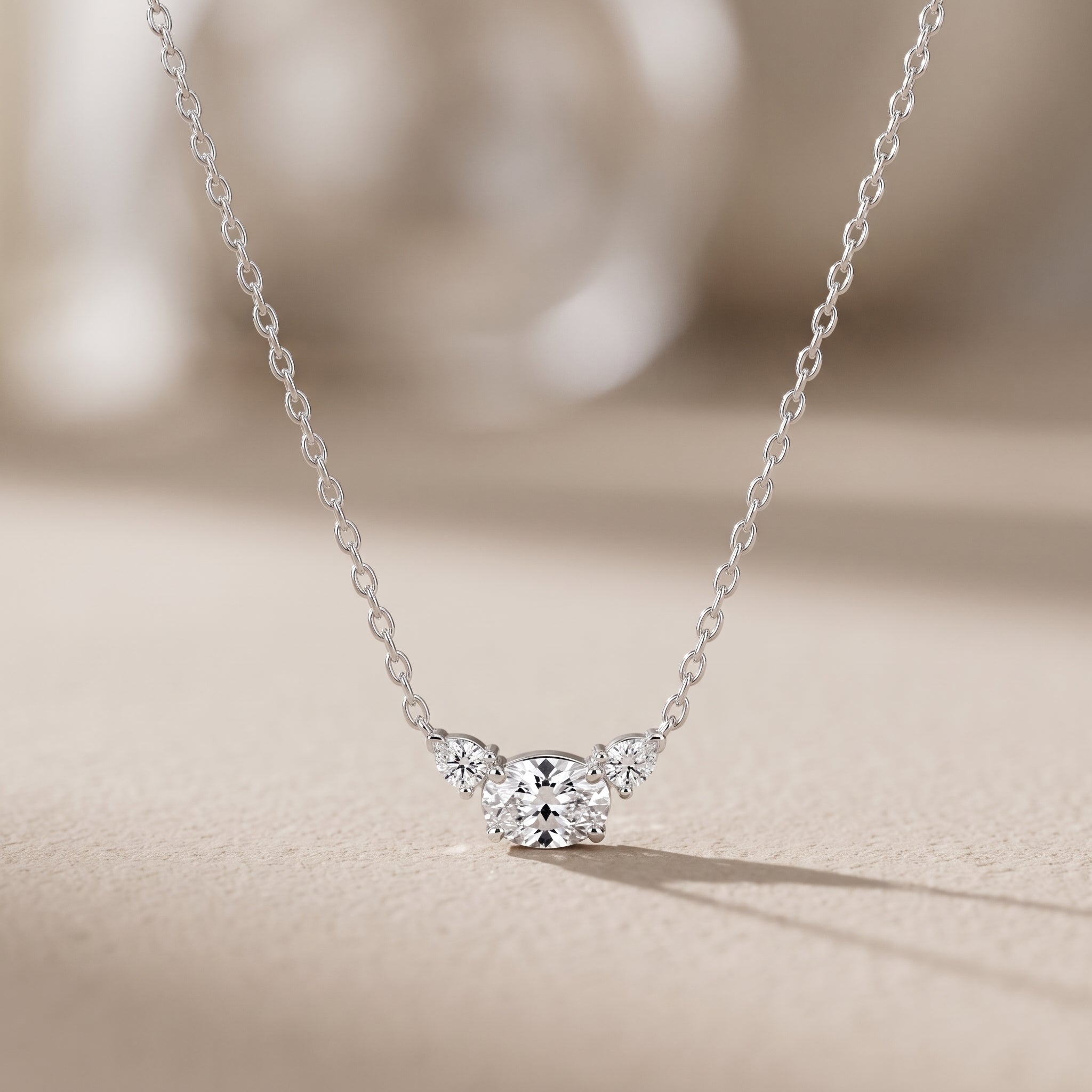 White Metal Oval Moissanite Three Stone Pendant Necklace