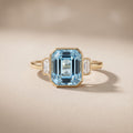 Yellow Gold Emerald Cut Blue Moissanite Three-Stone Ring